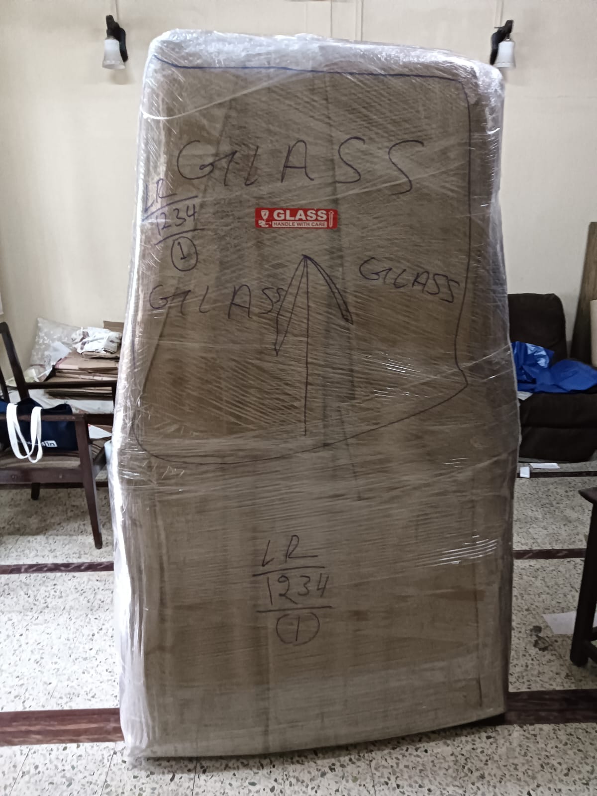 Glass item wrapped and marked handle with care by movers in Mulund