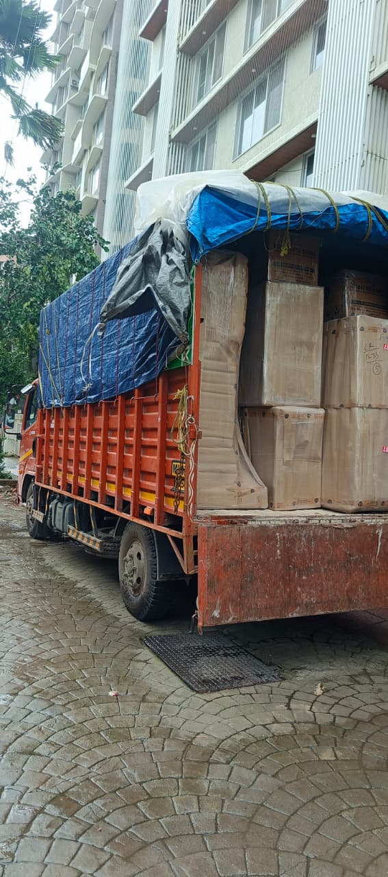 Covered truck loaded outside a residential tower in Mulund
